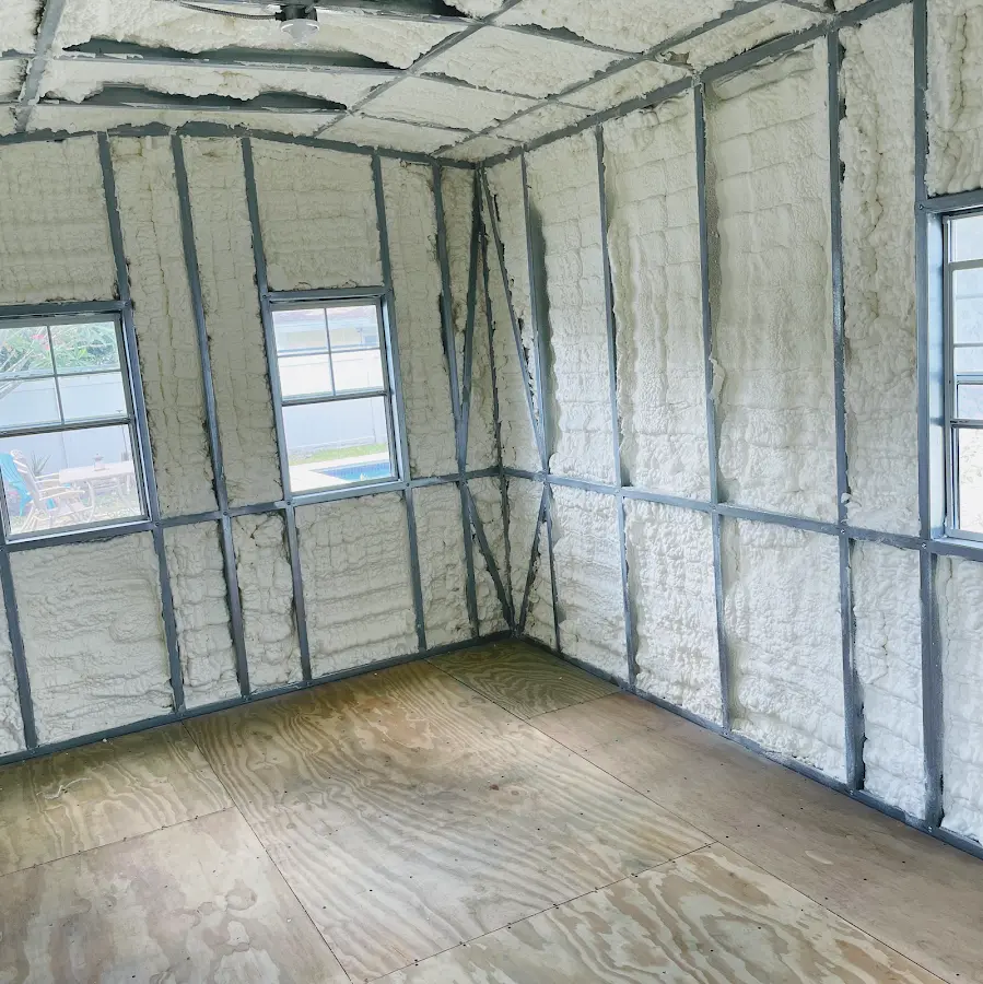 Closed-cell spray foam insulation applied to wall cavities in a residential project in Two Rivers